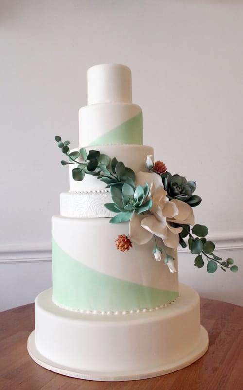Airbrushed wedding cake with sugar flowers spray